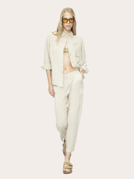 a woman in a bege outfit linen