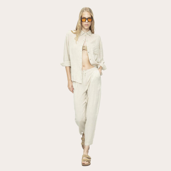 a woman in a bege outfit linen
