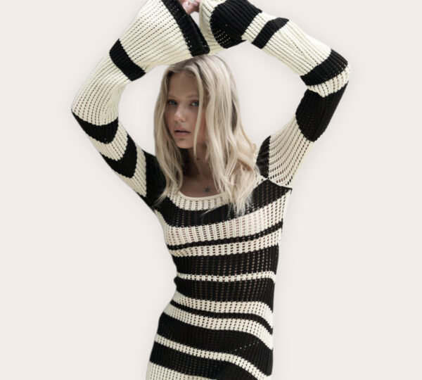 a woman in a black and white striped dress